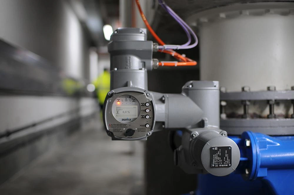 Electric valve actuator installed on a process valve for automated remote operation in an industrial facility.