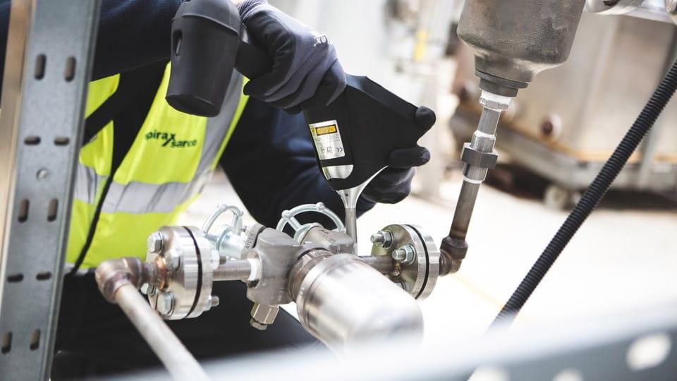 Technician inspecting and assembling an industrial valve fitting in Kenya