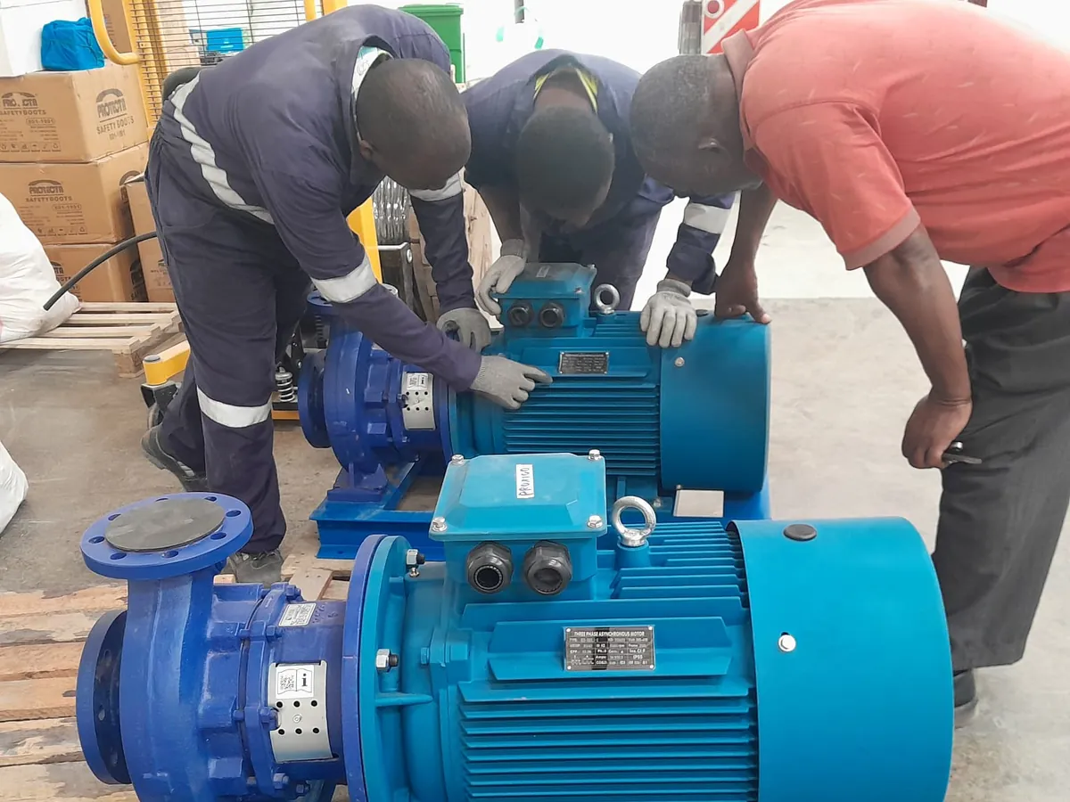 Technicians checking a pump set before dispatch