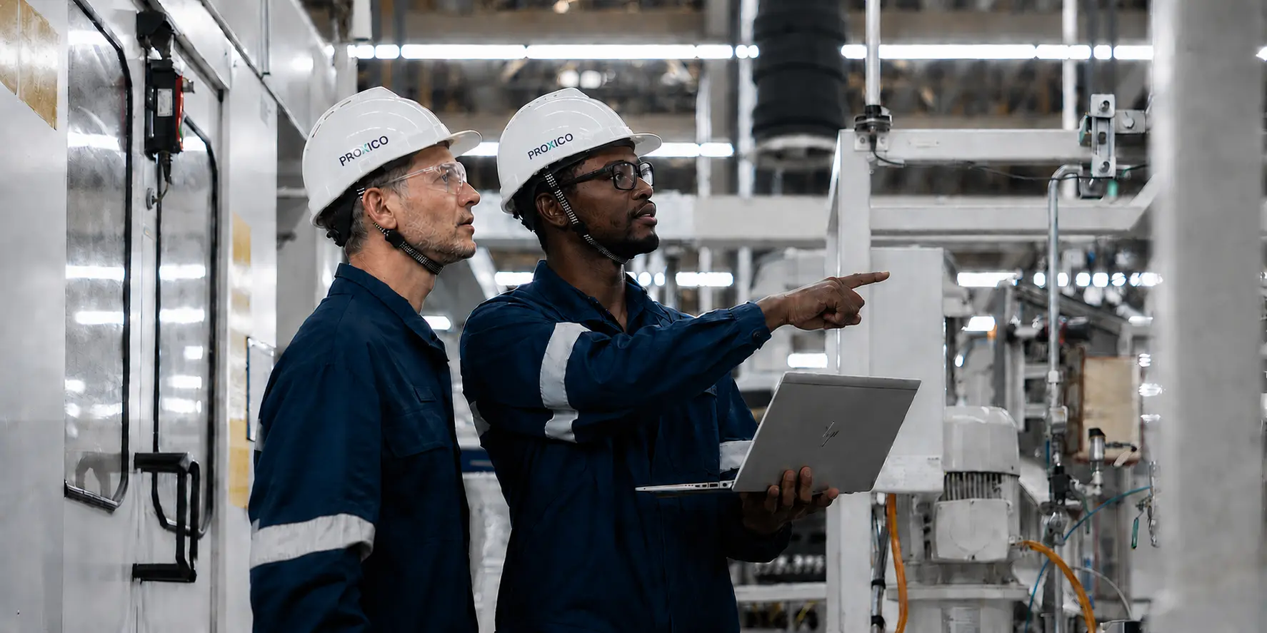 Proxico team discussing industrial equipment on site