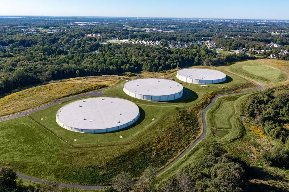 Large-scale industrial storage tank farm under bright daylight